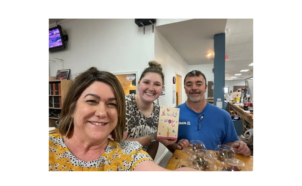 Alllison's Flooring America team photo with a thank you card! 